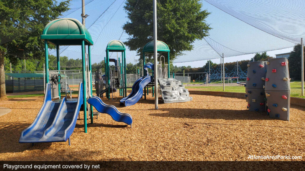 Chuck Camp Park Cobb Smyrna Playground equipment covered by net